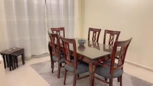 a dining room with a table and chairs at G Guest House in Amman +10 photos