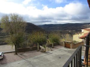 a balcony of a house with a view of mountains at Hostal Paquita in Allepuz