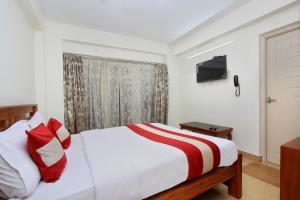 a hotel room with a bed and a television at OYO Home Stay Fable Stay in Ooty