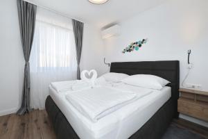 En eller flere senge i et værelse på Villa Tin Apartments