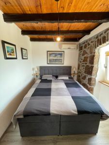 a bedroom with a large bed in a stone wall at Apartment Massimo in Rijeka +54 photos