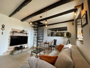 a living room with a couch and a tv at Apartment Massimo in Rijeka