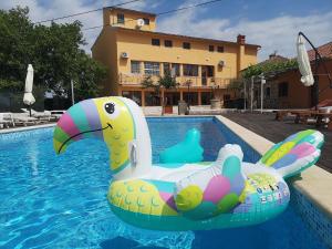 een zwembad met een opblaasbare noedel in het water bij Extra komfortables Ferienhaus mit großem Pool in Mutvoran