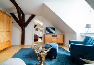 a living room with a blue couch and a table at Schloss Harkensee in Dassow