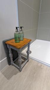 a table with three bottles on it in a bathroom at Eakie House Apartments - Kinlochleven in Kinlochleven