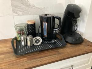 a coffee maker on a tray on a counter at Apartment mit Seeblick in Feld am See