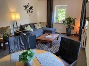 a living room with a couch and a table at Apartment mit Seeblick in Feld am See