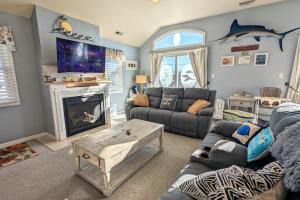 a living room with couches and a shark on the wall at Waves n Wooder by AvantStay SwimSpa Game Room Walk to Beach in Wildwood