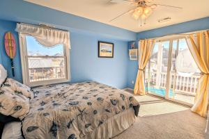 a bedroom with blue walls and a bed and a window at Waves n Wooder by AvantStay SwimSpa Game Room Walk to Beach in Wildwood