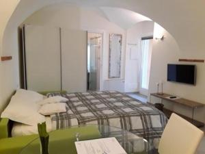 um quarto com uma cama e um sofá verde em Schönes Appartement in Toscolano Maderno mit Terrasse und Garten em Toscolano Maderno