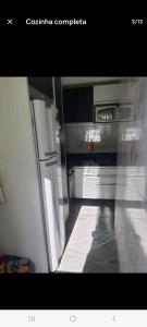 an empty kitchen with a refrigerator and a stove at Apto Sirius 31 in Cascavel