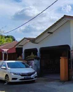 a car parked in front of a garage at Sobey Laris Homestay PASIR MAS LATI in Pasir Mas
