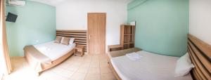 a room with two beds in a room at Μpasias Apartments in Paralia Katerinis