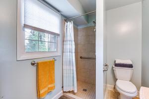 a bathroom with a toilet and a window at Eclectic Winston-Salem Home 3 Mi to Downtown! in Winston-Salem