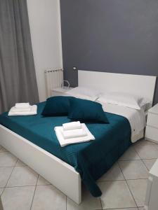 a bed with two towels on top of it at La Perla del Mare - 9 minutes from FCO Airport - Free WiFi e Netflix in Fiumicino