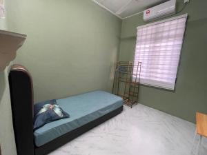 a small bedroom with a bed and a window at Salam homestay in Kepala Batas