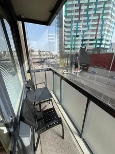 a chair sitting on the balcony of a building at Studio next to Sello and Leppävaara train station in Espoo +4 photos