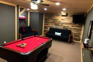 a living room with a pool table and a couch at Journeys End Chalet - Minutes to Jay Peak! in Jay