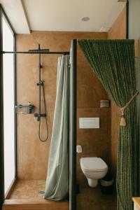 a bathroom with a toilet and a shower with a shower curtain at Casa Africa in Tarifa