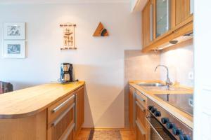 a kitchen with a sink and a counter top at Auszeit in Schilksee