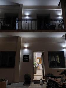 two levels of a building with a door and a balcony at Porto Chania in Chania