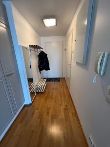 a room with a hallway with a door and wooden floors at Studio next to Sello and Leppävaara train station in Espoo