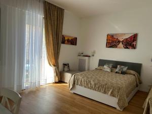 a bedroom with a bed and a large window at Casa di Taty B&B in Mestre