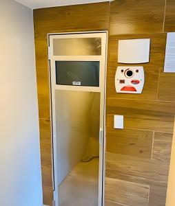 - une porte en verre avec une télévision dans la chambre dans l'établissement Aptos super confortáveis no Gold Flat by Apartamentos Jampa, à João Pessoa