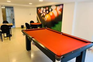um escritório com uma mesa de bilhar num quarto em Aptos super confortáveis no Gold Flat by Apartamentos Jampa em João Pessoa