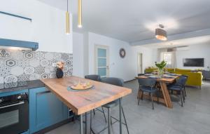uma cozinha e sala de estar com mesa e cadeiras em Villa Daniela für 6 Personen in Porec, Salzwasserpool, Garten mit Grill em Veleniki