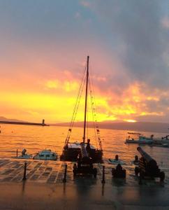 a couple of boats parked on a dock with a sunset at Mirna in Senj
