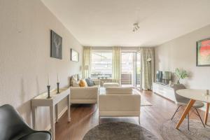 a living room with a couch and a table at Ferienwohnung Beachside in Strande