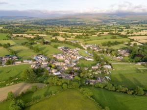 an aerial view of a village in the hills at Old St Lukes Church in Soulby