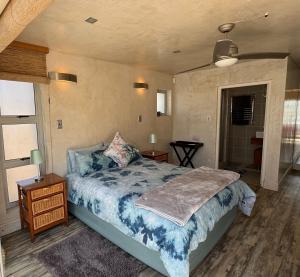 a bedroom with a bed and two tables and a window at Cozy family beachfront house. in Langstrand