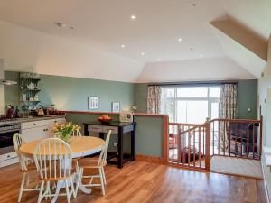 a kitchen and dining room with a table and chairs at Kilduncan Barn in Kingsbarns