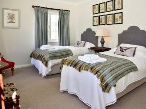 a bedroom with two beds with towels on them at Glanusk Lodge - Uk46654 in Crickhowell