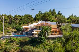 a house on the side of a hill at Avgeri Villa in Skopelos Town