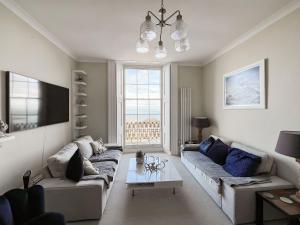 a living room with a couch and a table at Admirals Lookout in Ilfracombe