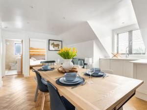 a kitchen and dining room with a wooden table and chairs at Stargazing in Filby