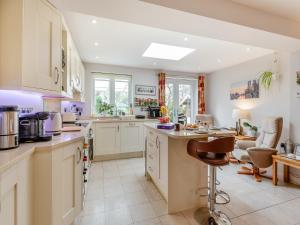 a kitchen with white cabinets and a counter top at Riverview in Market Deeping
