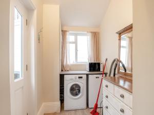 a laundry room with a washer and dryer in it at The Old Ballroom in Norwich