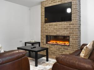 a living room with two couches and a fireplace at Gadebridge in Thornaby on Tees