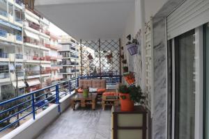 a balcony with a couch and a table in a warehouse at Άνετο και όμορφο διαμέρισμα in Xanthi