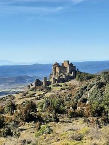 an old castle on top of a hill at Hotel Rural Flor de Almendro in Loarre