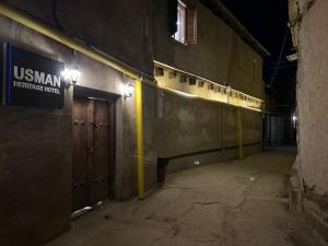 an empty hallway of a building at night at Usman Heritage Hotel in Bukhara