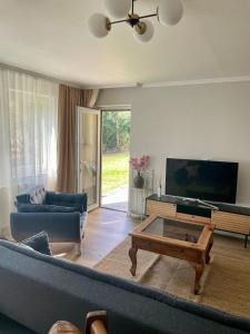 a living room with a couch and a coffee table at Apartment by the park, for bike lovers in Alsfeld