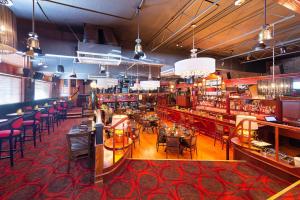 a restaurant with tables and chairs and a bar at Best Western Plus Columbia River Hotel in Trail