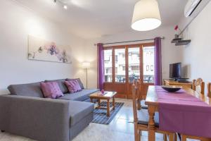 a living room with a couch and a table at Appartement in Son Baulo mit Grill in Can Picafort