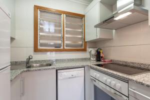a kitchen with a sink and a counter top at Appartement in Son Baulo mit Grill in Can Picafort