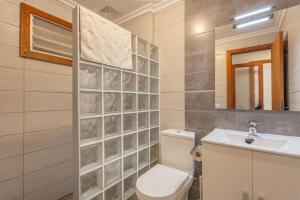 a bathroom with a toilet and a sink at Appartement in Son Baulo mit Grill in Can Picafort +12 photos